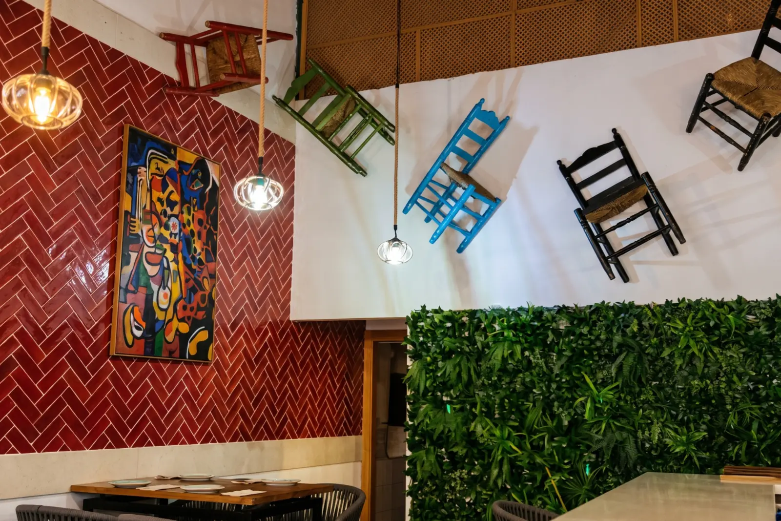 Coloured chairs hanging from the ceiling at Mi Locura